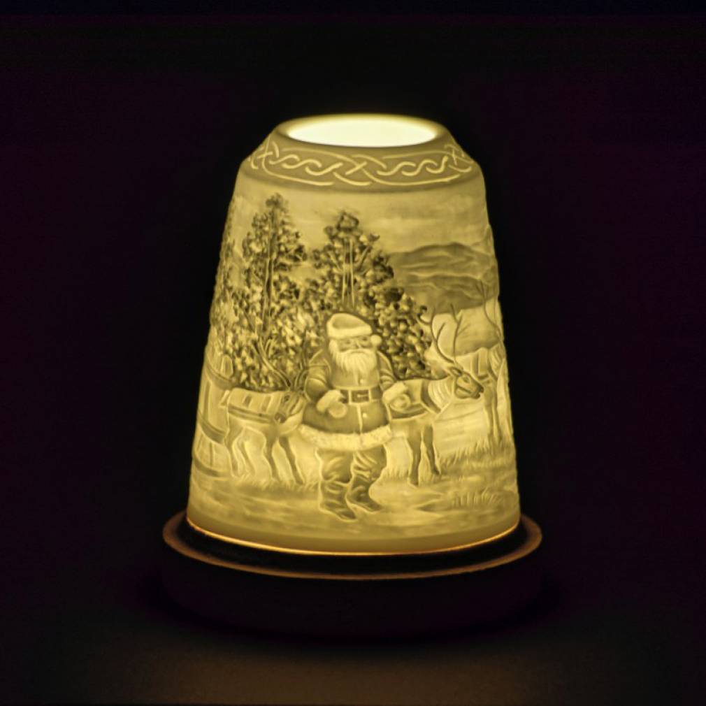 Ceramic Christmas lantern featuring Santa Claus with reindeer and trees in intricate relief design.