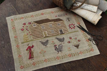 Rustic cross-stitch farmhouse design on linen fabric, featuring chickens and floral motifs.