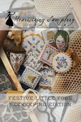 Set of festive cross-stitch beekeeping-themed ornaments in various colors and designs, ideal for home decor.