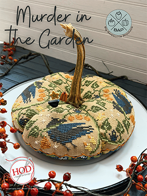 Decorative 'Murder in the Garden' pumpkin pillow, floral pattern, plush fabric, autumn decor.