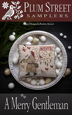 A Merry Gentleman decorative pillow, featuring embroidery of a man, birds, and floral designs on linen.