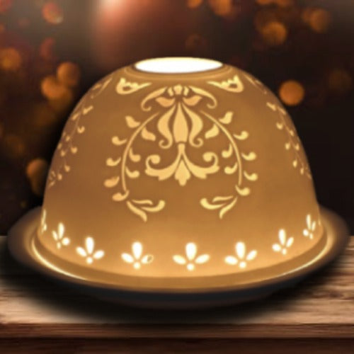 Delicate amber ceramic lamp with floral cutouts, creating a warm glow for home decor.
