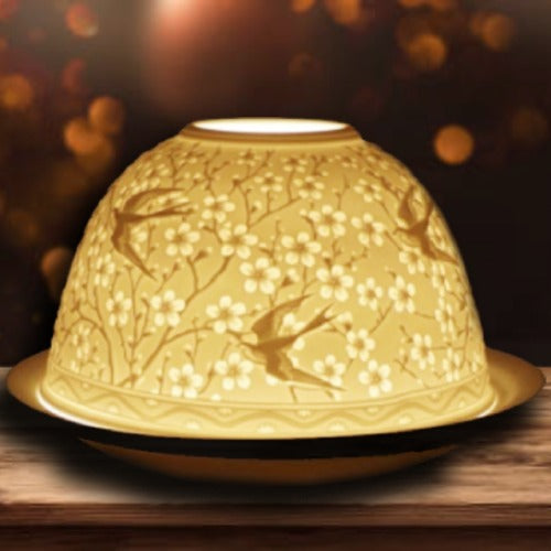 Elegant yellow ceramic dome with floral and bird design, perfect for serving dishes.