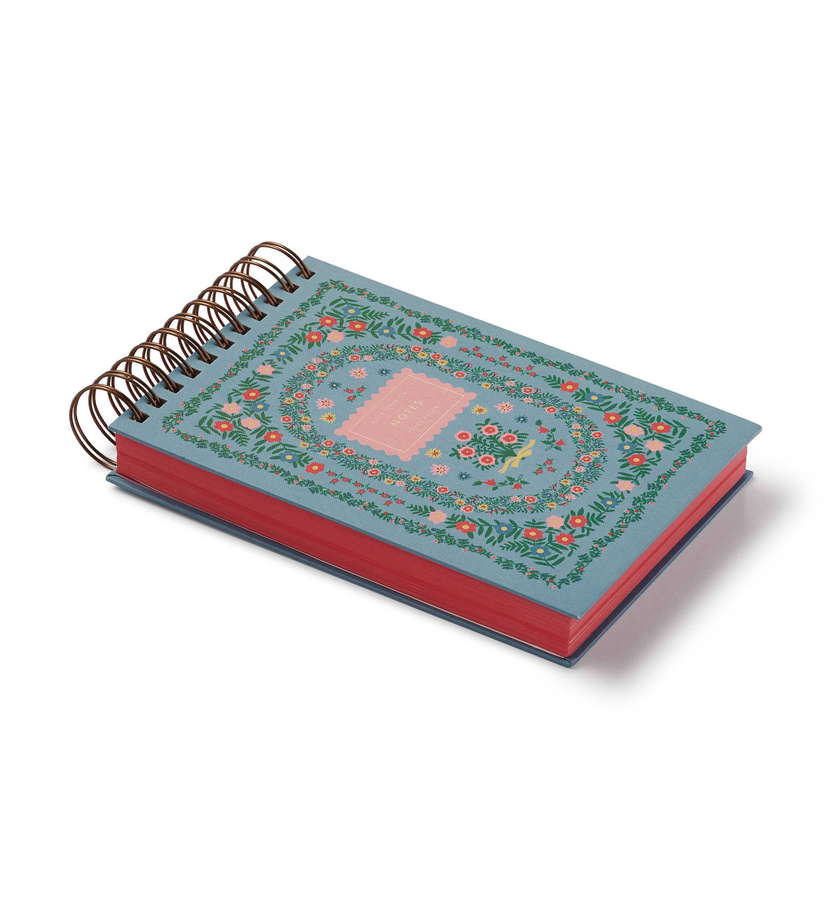 Spiral-bound journal with floral design, blue cover, and red pages, perfect for notes or sketches.