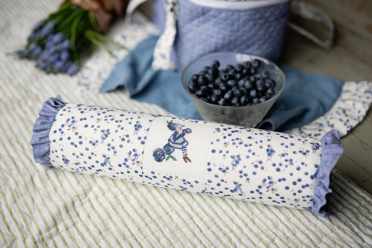 Decorative blue patterned fabric roll, featuring floral design and ruffled edges, ideal for home decor.