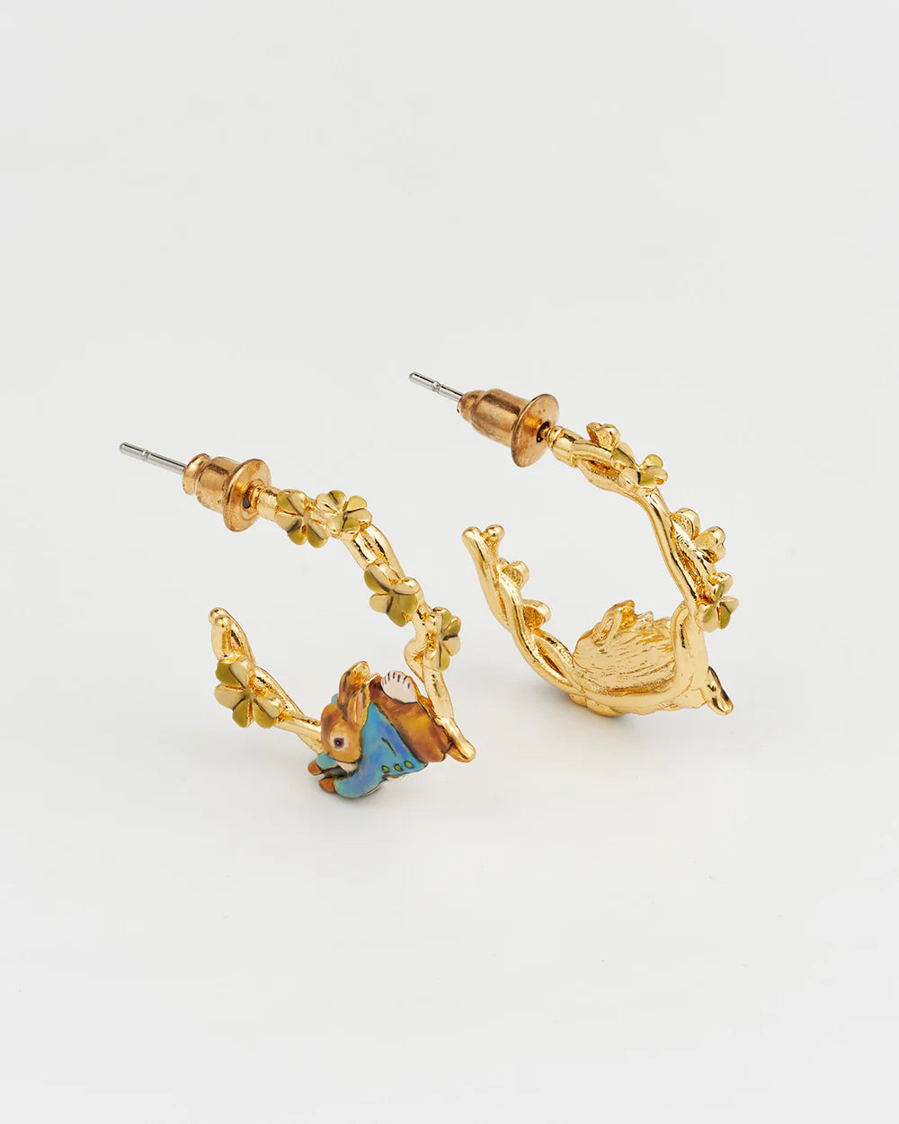 Gold hoop earrings featuring floral designs and colorful animal charms.