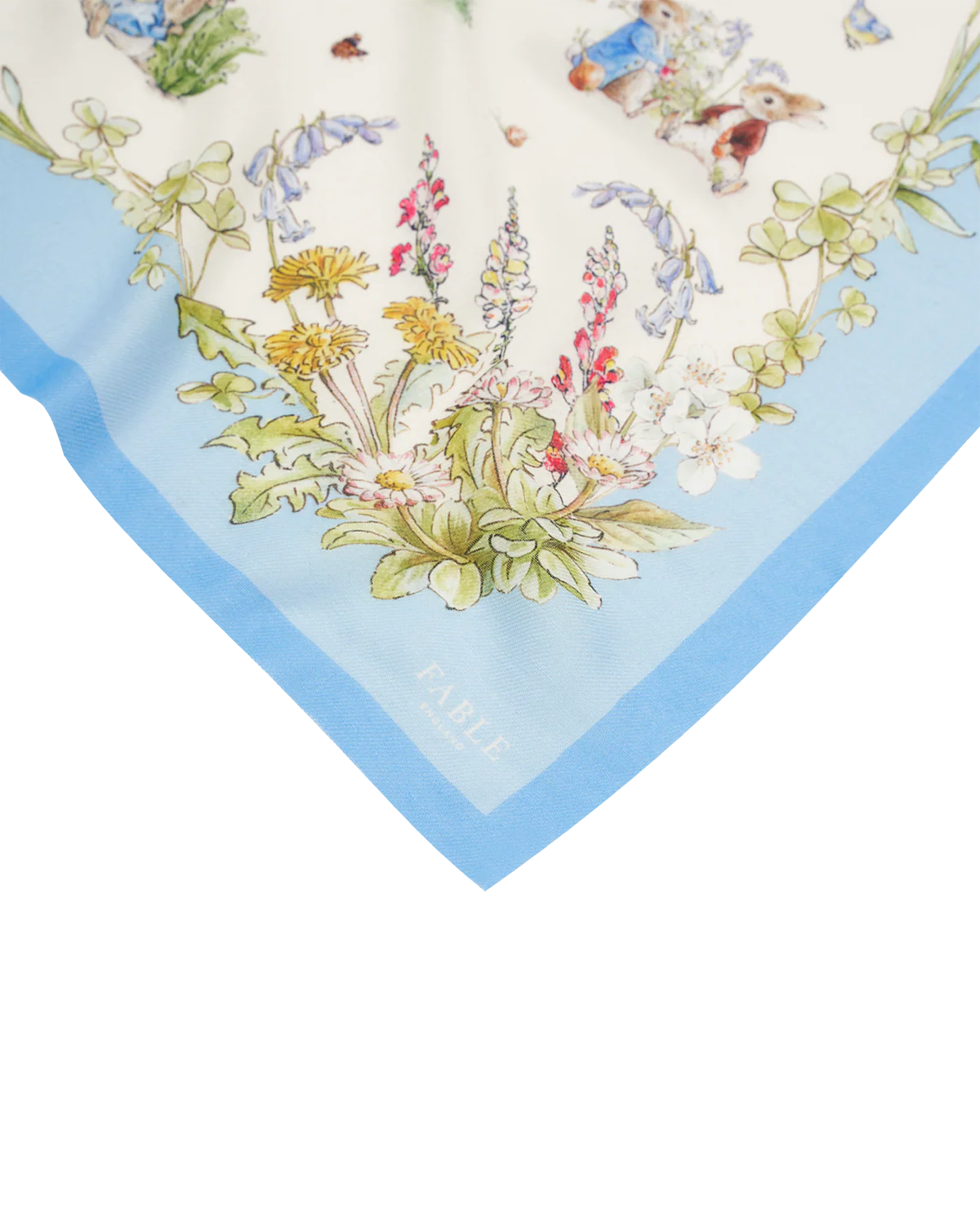 Floral silk scarf in blue and cream, featuring intricate garden designs and a FABLE label.