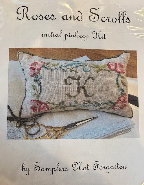 Roses and Scrolls initial pinkeep kit featuring floral design and letter 'K' on linen with sewing tools.