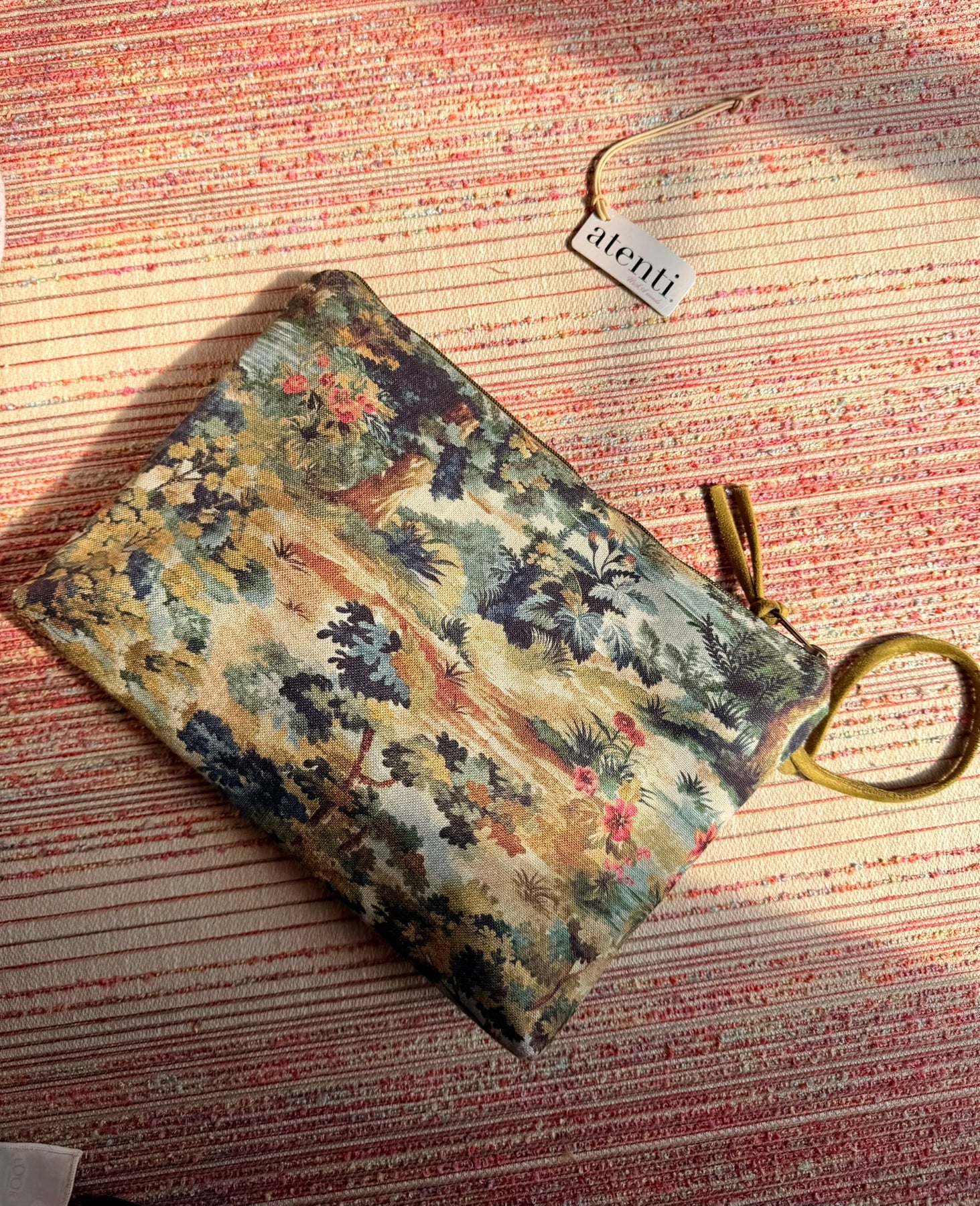 Floral-patterned pouch in green and yellow fabric, perfect for cosmetics or accessories.