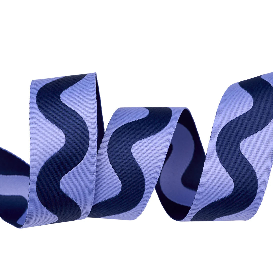 Purple wavy ribbon with navy accents, perfect for crafts and decorations, made from durable polyester.