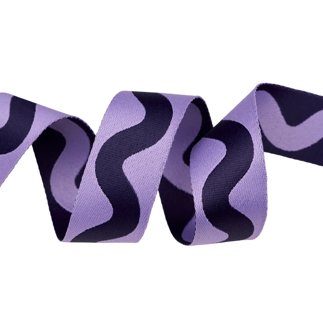 Purple patterned ribbon with wavy black design, perfect for crafts and gift wrapping.