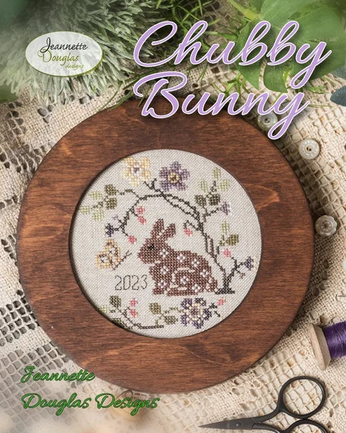 Chubby Bunny cross stitch design by Jeannette Douglas, featuring a brown bunny and floral elements.