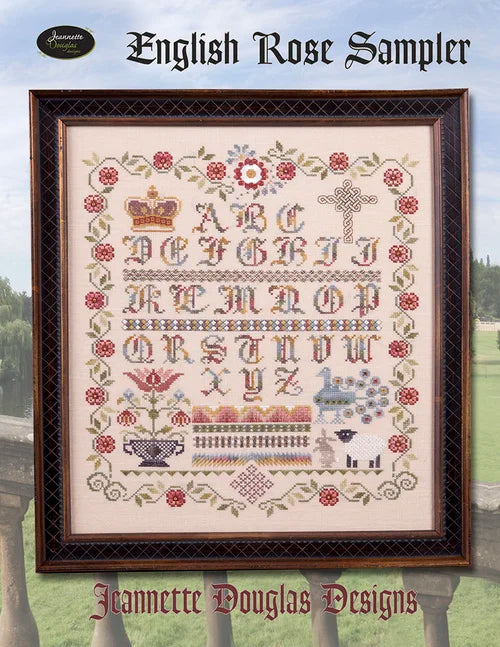 Framed English Rose Sampler by Jeannette Douglas Designs with floral and alphabet motifs in pastel colors.