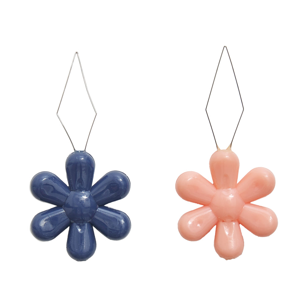 Blue and pink flower-shaped earrings with a glossy finish and metal hooks, perfect for a fun accessory.