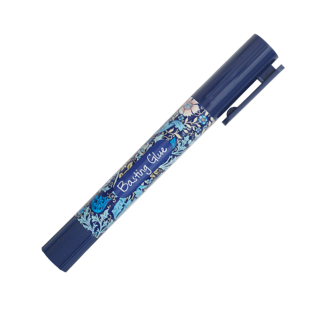 Navy blue basting glue pen with floral design, ideal for fabric crafting and quilting projects.