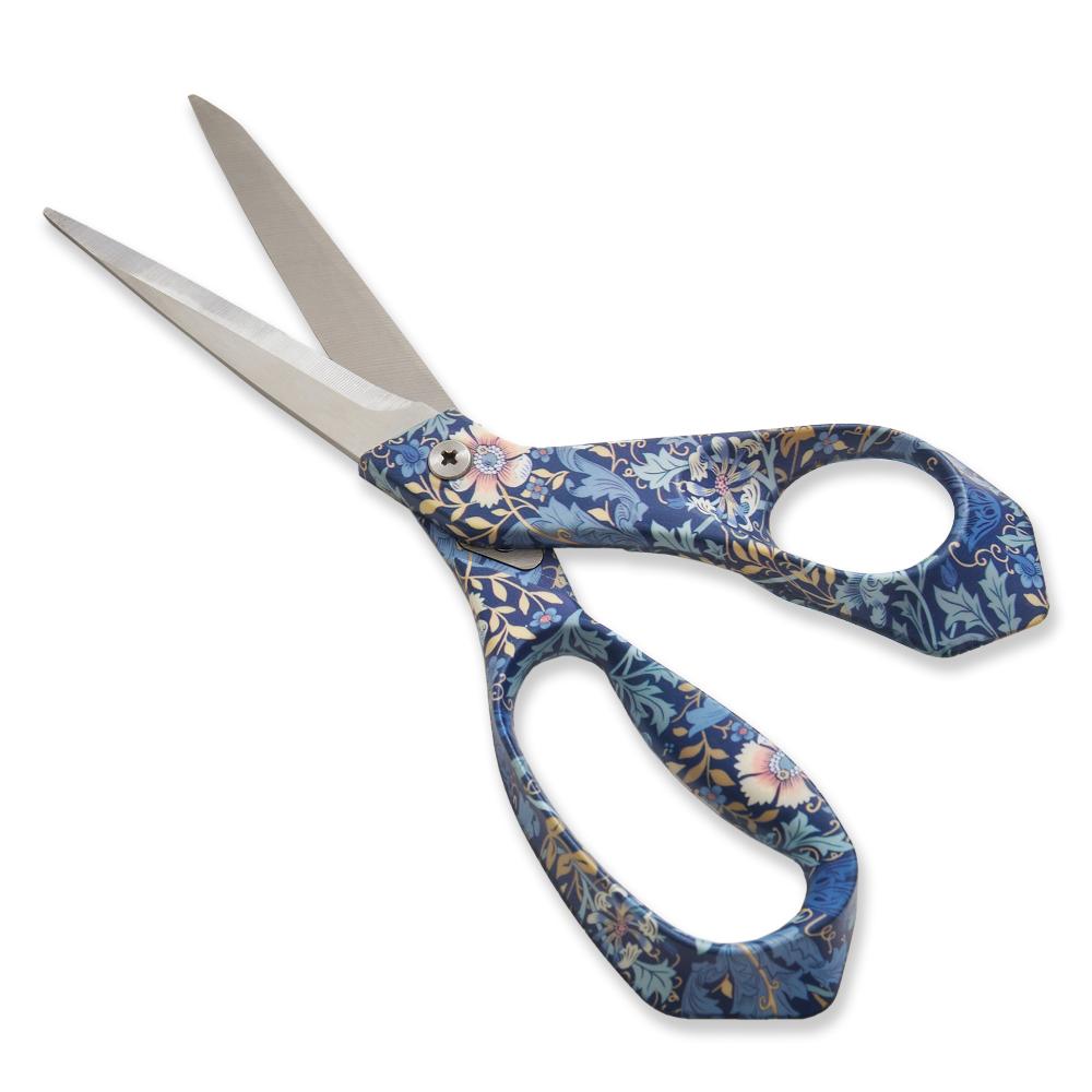 Floral patterned fabric scissors with stainless steel blades and ergonomic, blue handles.
