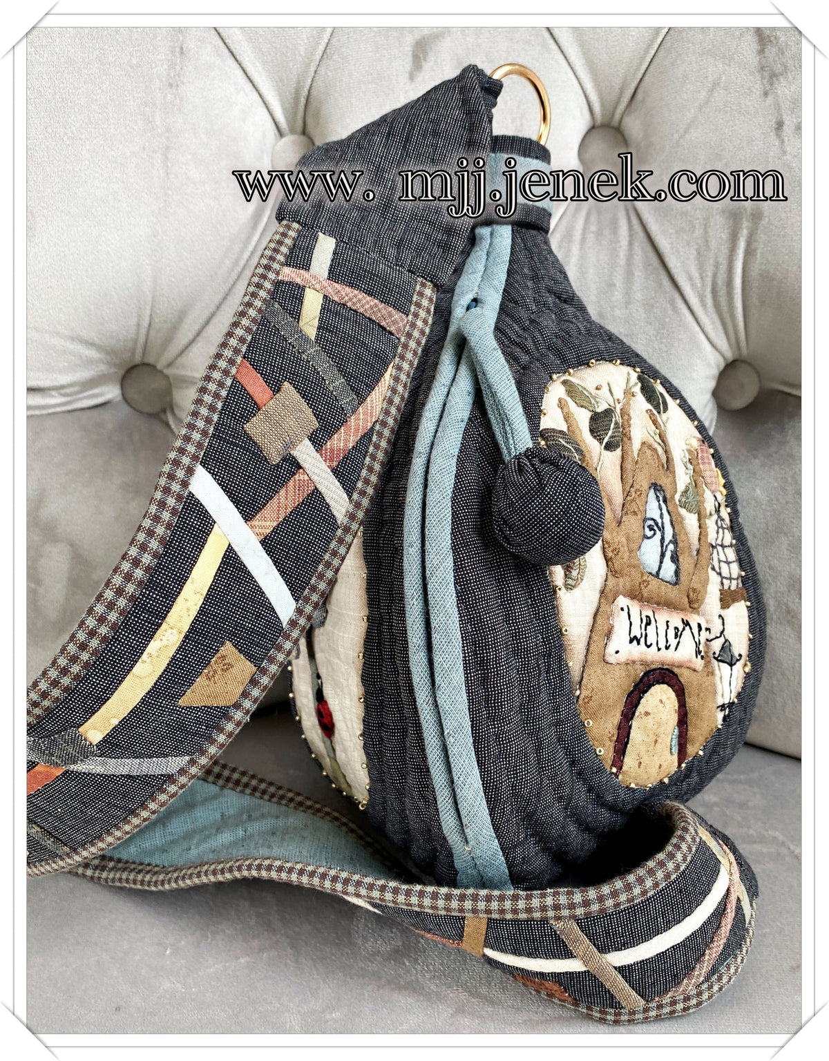 Unique fabric handbag with intricate patterns, black and multicolored, made of durable textile material.