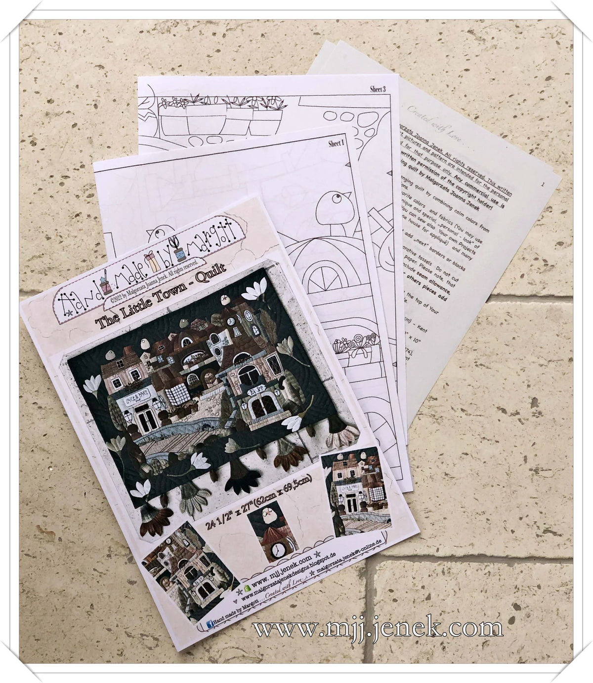 The Little Town Quilt pattern, multi-colored fabric design, 24.5" x 27" size, includes detailed instructions.