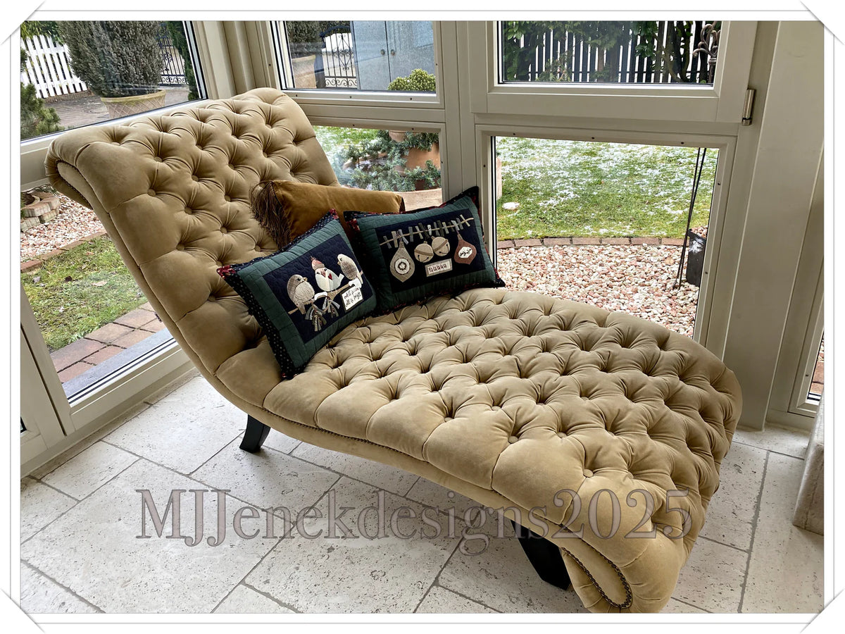 Beige velvet chaise lounge with tufted design and decorative pillows, ideal for stylish home decor.