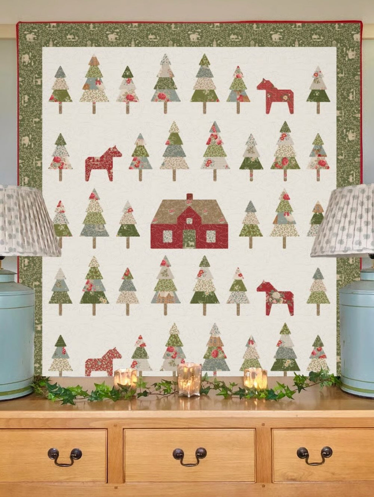 Festive quilt featuring colorful trees, a red house, and a horse, designed in cotton fabric, perfect for holiday decor.