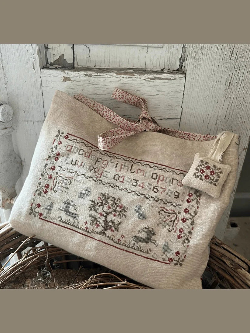 Embroidered linen pouch with floral design, featuring a small matching tag. Perfect for storage.