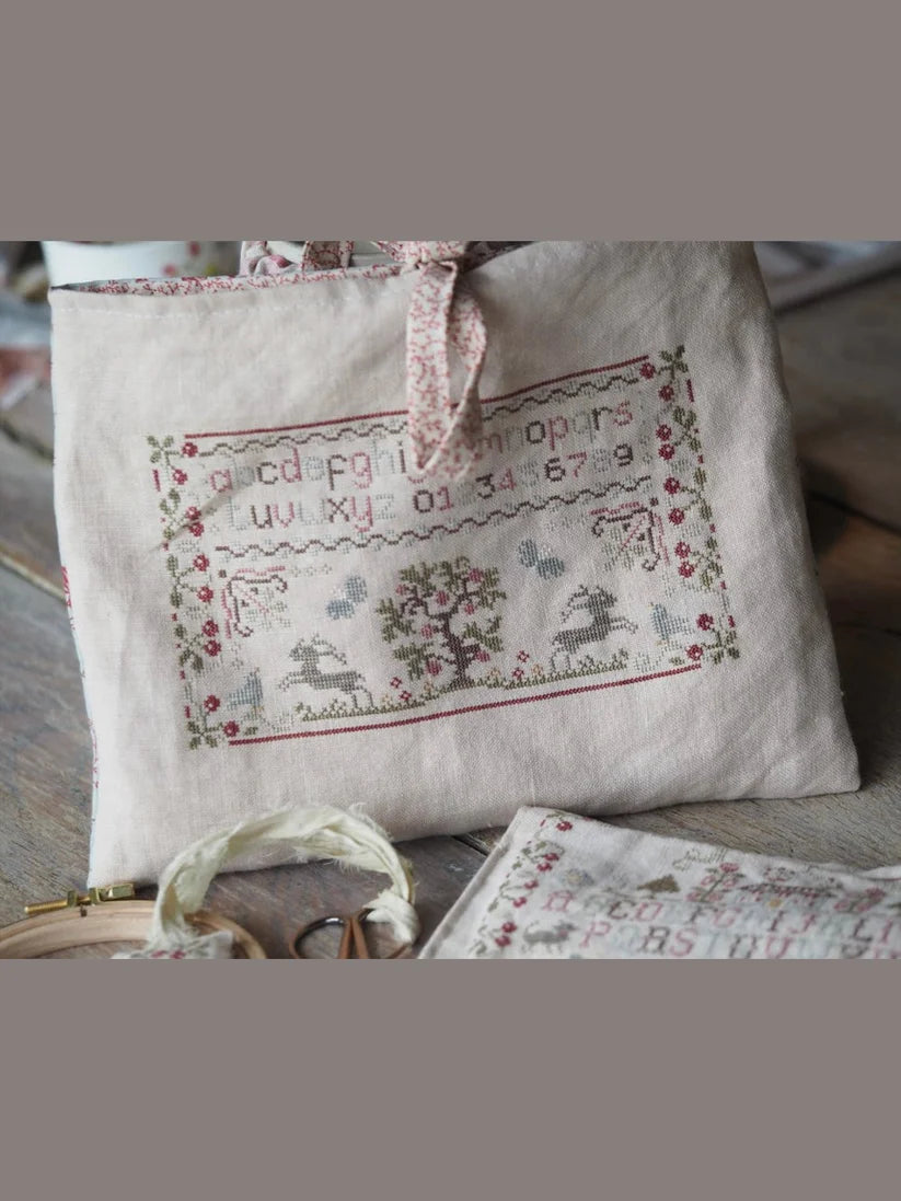Embroidered linen pouch with floral design and alphabet, perfect for storage and organization.