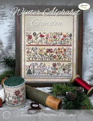 Framed Winter Alphabet Garden cross-stitch art with vibrant flowers and letters, featuring rich colors and intricate details.