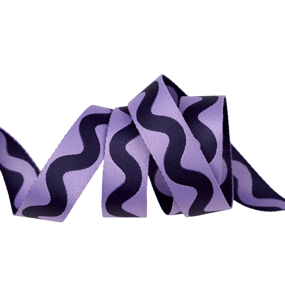 Purple wavy patterned ribbon, made from durable material, ideal for crafting and decorating.