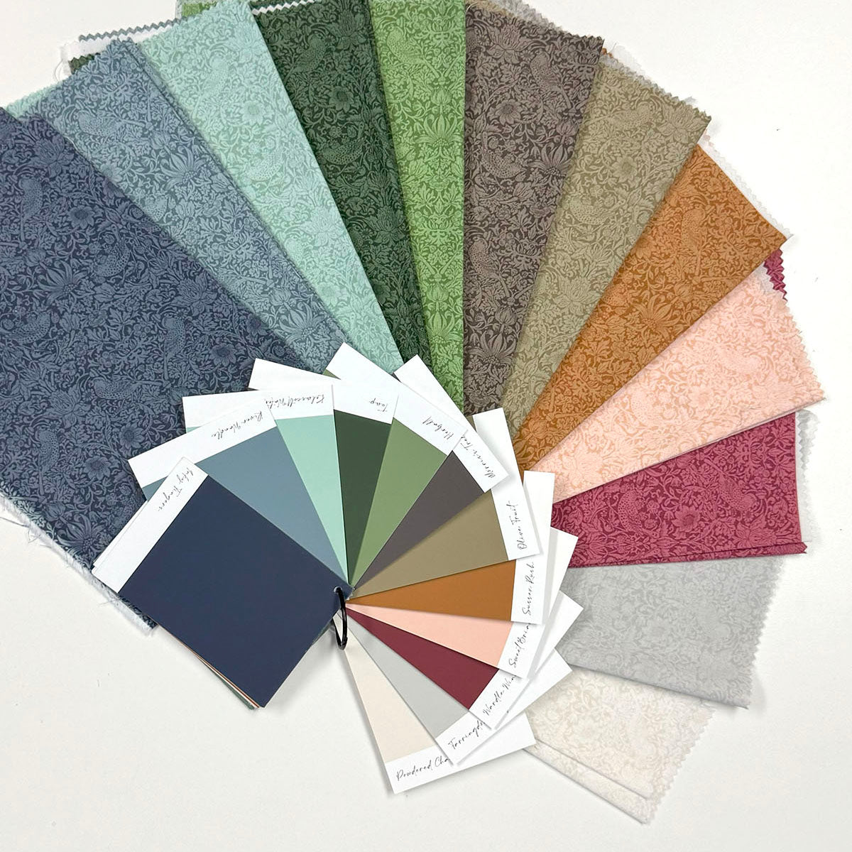 Assorted floral patterned fabric swatches in various colors including green, blue, orange, and pink.