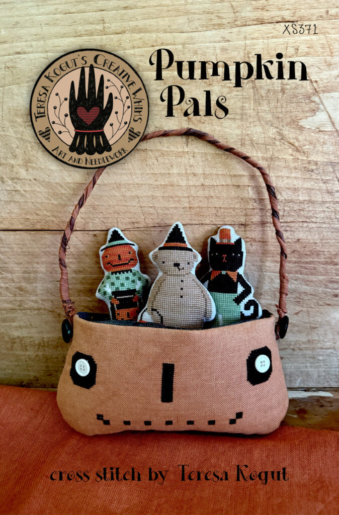 Pumpkin Pals cross stitch kit by Teresa Kogut, featuring soft fabric basket with colorful stitched figures.