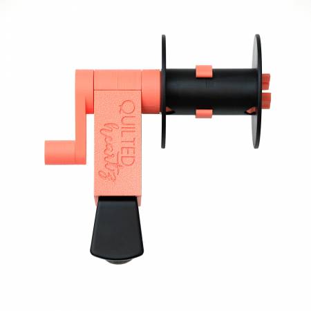 Quilted gear hand crank tool in coral and black, ideal for quilting and crafting projects.