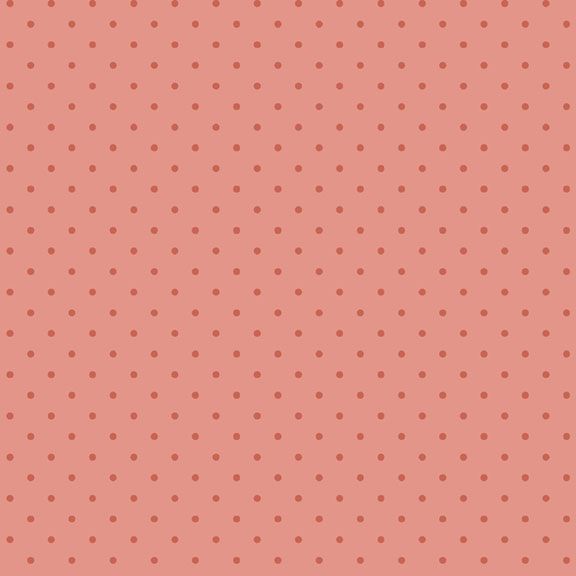 Soft coral polka dot fabric, perfect for crafting and home décor projects.