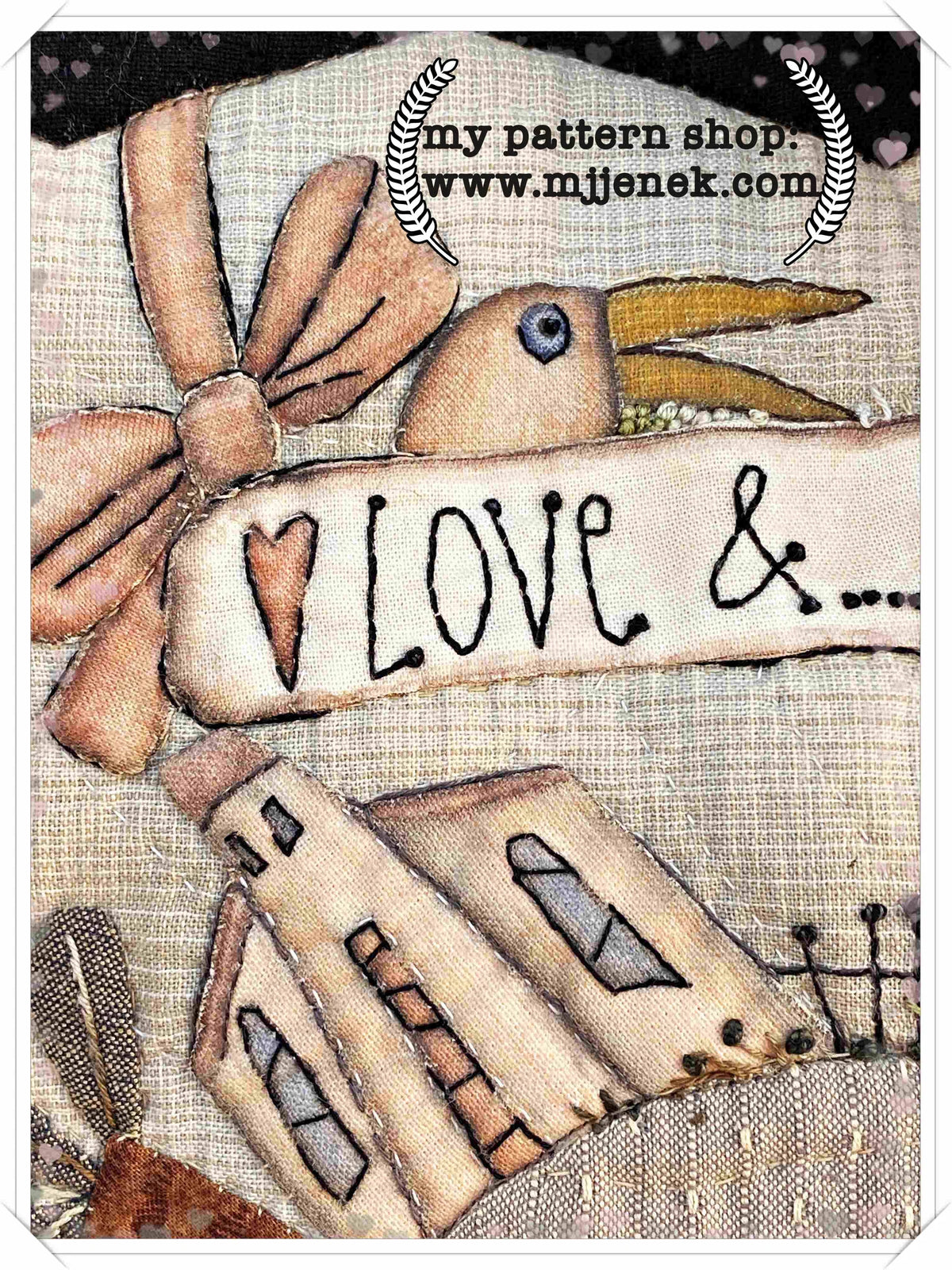 Vintage fabric panel featuring a stitched bird and the word 'Love' with a whimsical house design.