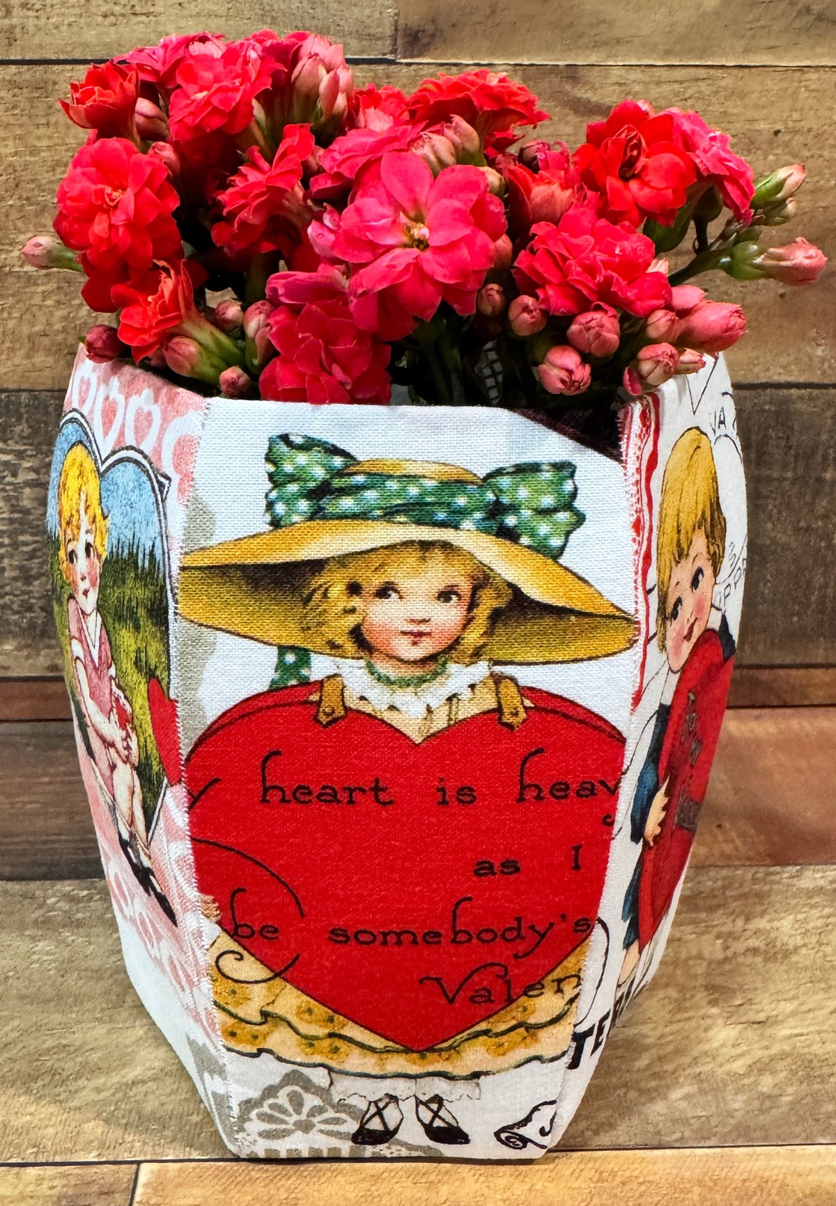 Vintage floral planter with red flowers, featuring heart and vintage illustrations on cotton fabric.