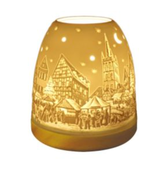 Ceramic decorative lamp in warm amber color featuring a festive winter scene with markets and buildings.