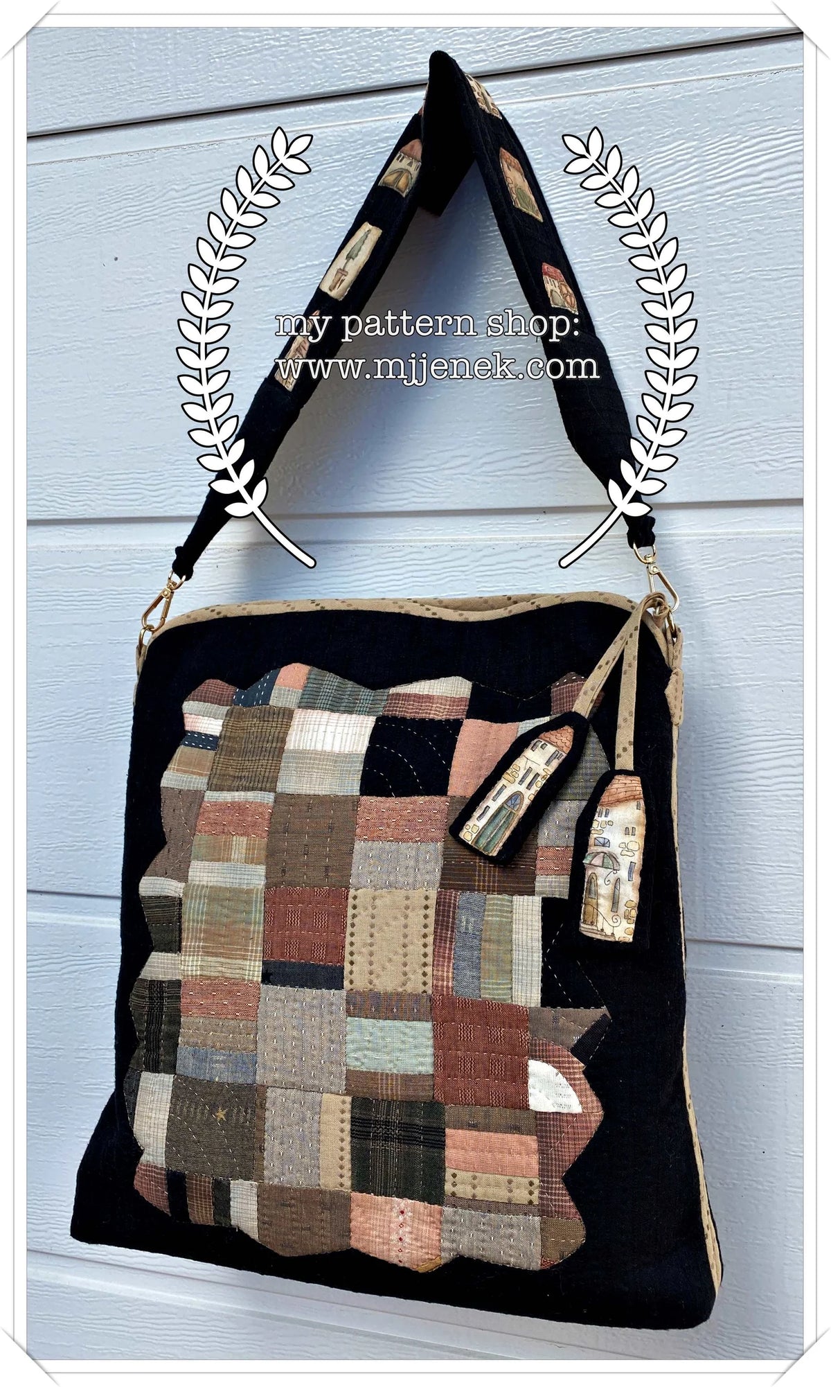 Handmade quilted bag in black, featuring a patchwork design with earthy tones and a stylish strap.