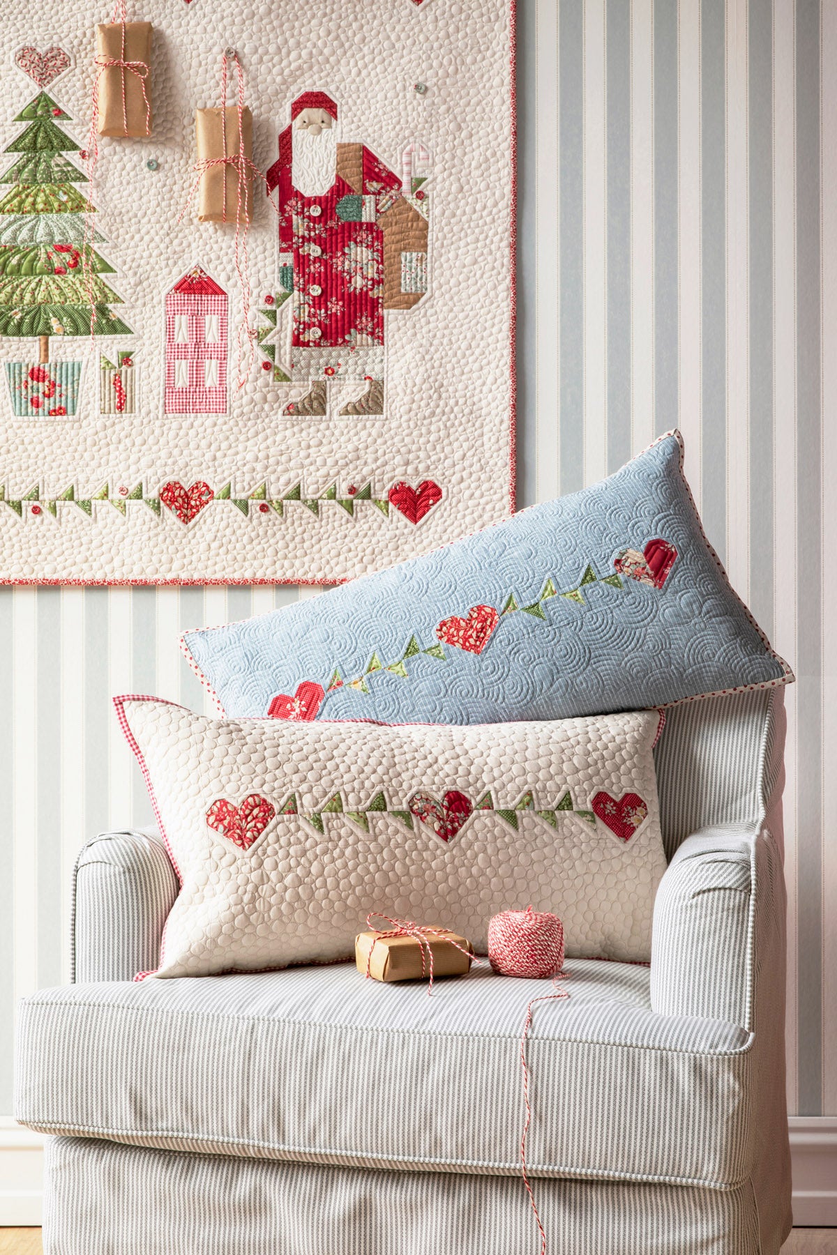 Two decorative pillows in blue and cream with heart designs, perfect for festive home decor.