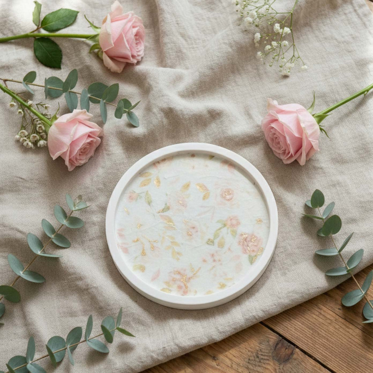 Round floral serving tray in white with pastel flowers, perfect for home decor and gatherings.