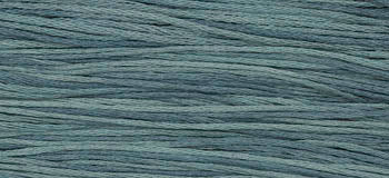 Soft cotton yarn in muted teal color, perfect for knitting and crafting projects.