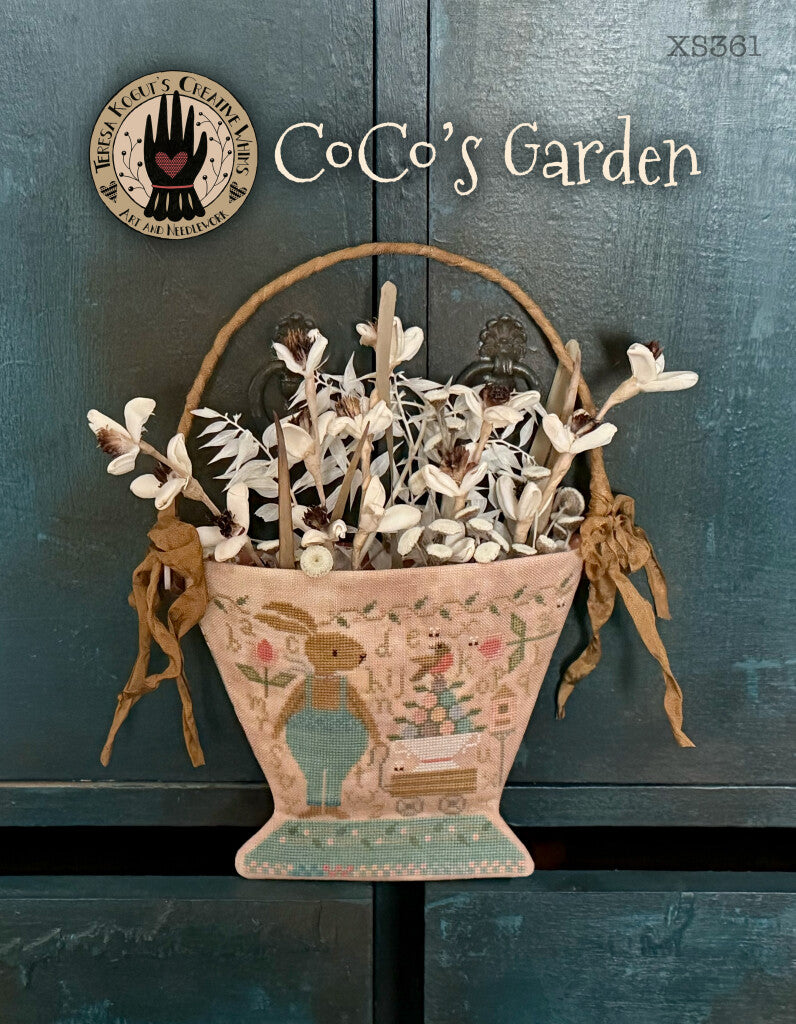 Ceramic garden pot featuring a bunny design, filled with dried flowers, in soft peach and teal colors.