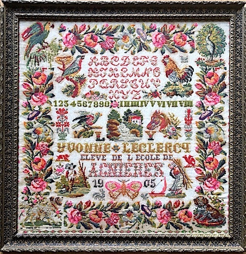 Vintage cross-stitch embroidery art in ornate frame featuring floral and animal motifs, colorful 1905 design.