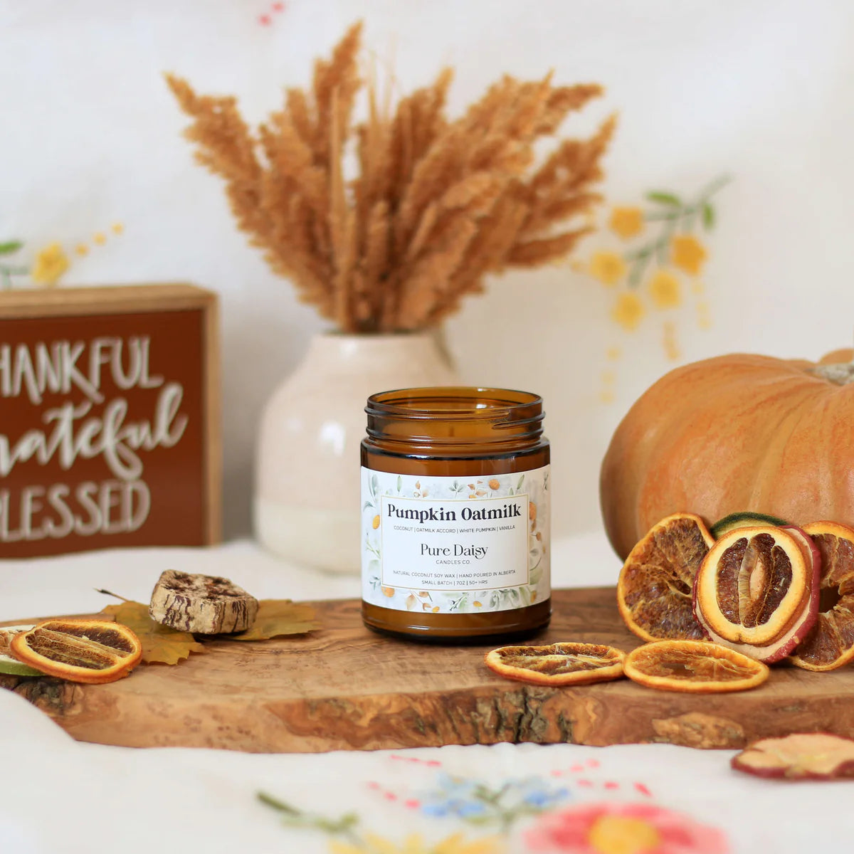 Pumpkin Oatmik candle by Pure Daisy, amber glass jar, coconut wax, seasonal fragrance with pumpkin and vanilla.