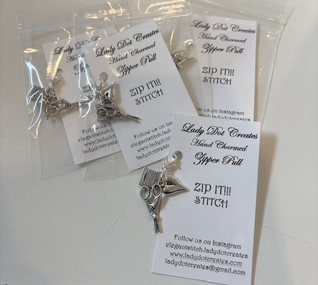 Handcrafted silver zipper pulls featuring sewing scissors and a spool, perfect for crafters and sewing enthusiasts.