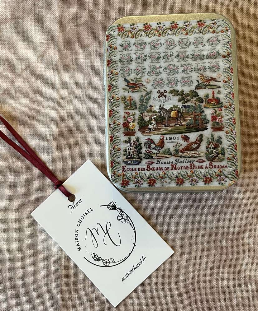 Vintage metal tin featuring colorful floral patterns, labeled 'Souvenir 1901', from Ecole des Soeurs de Notre-Dame.