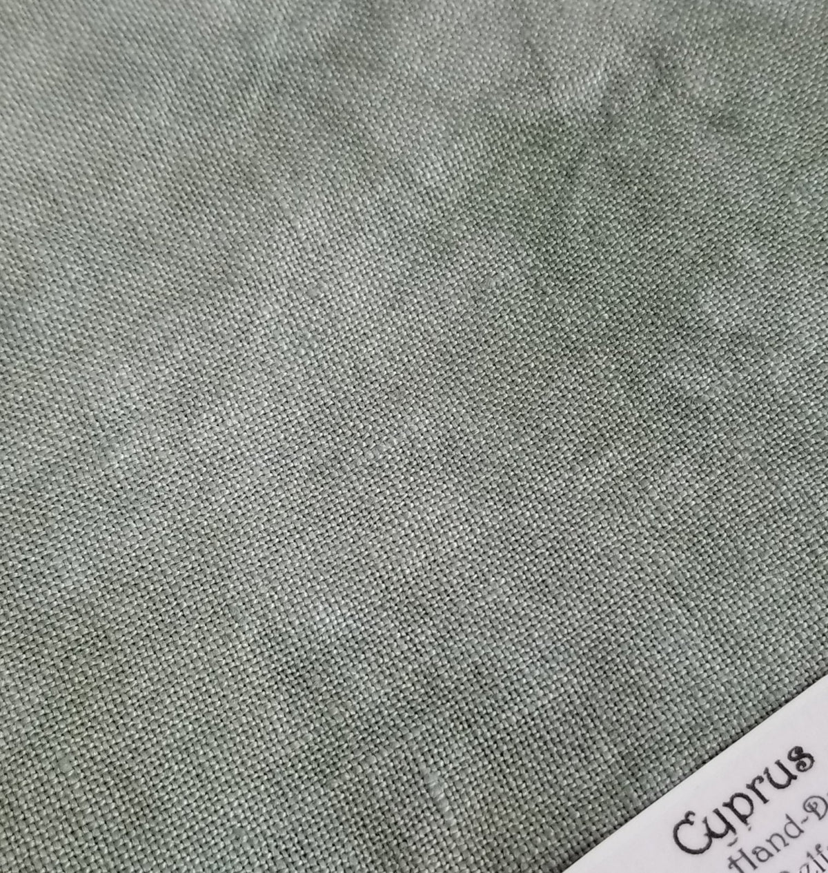 Hand-dyed Cyprus fabric in a soft green color, perfect for crafting and sewing projects.