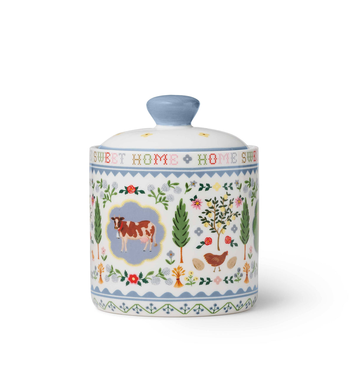 Ceramic decorative canister with cow and floral designs, featuring a light blue lid and 'Sweet Home' text.