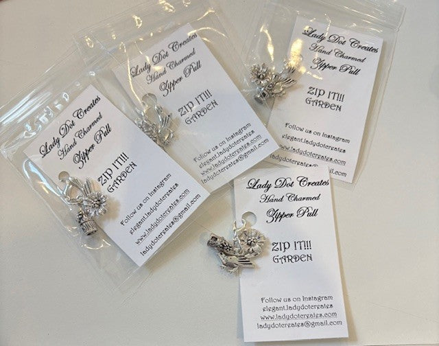Handcrafted silver garden-themed zipper pulls by Lady Dee Creates, featuring floral and bird designs.