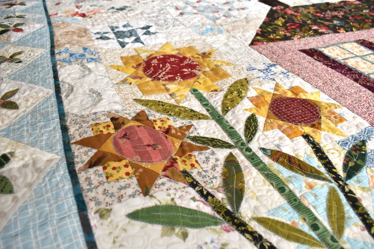 Colorful quilt featuring floral patterns, made from cotton fabric with intricate stitching and quilting.