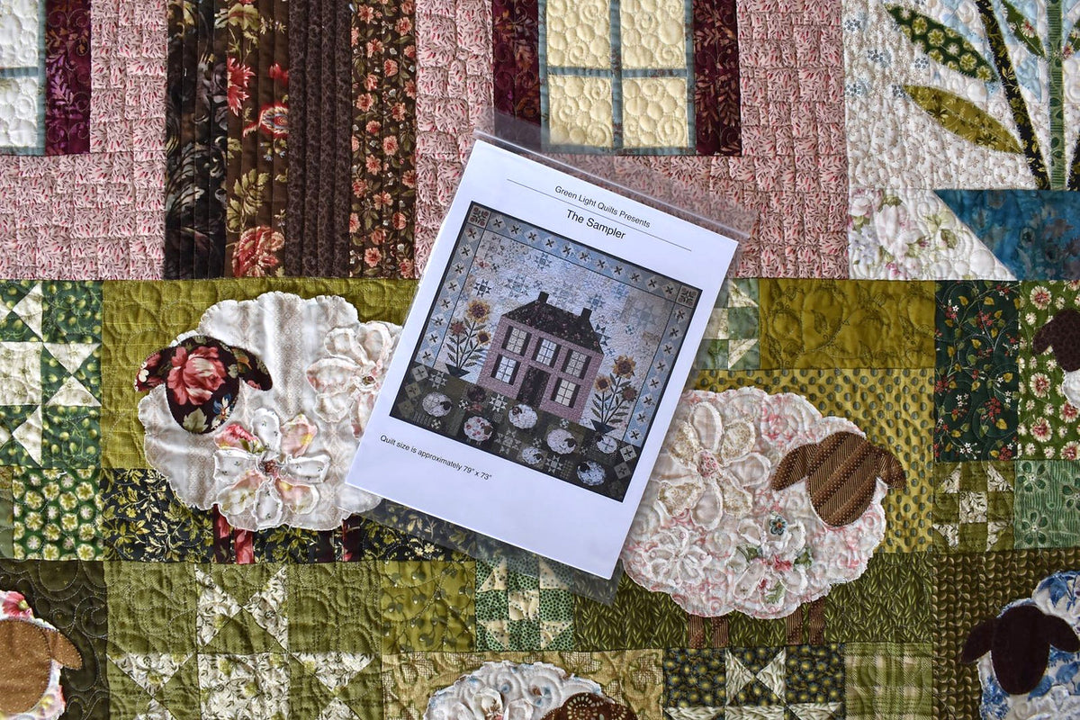 Colorful quilt featuring floral patterns and sheep motifs, with pattern instruction booklet, size 79" x 73".
