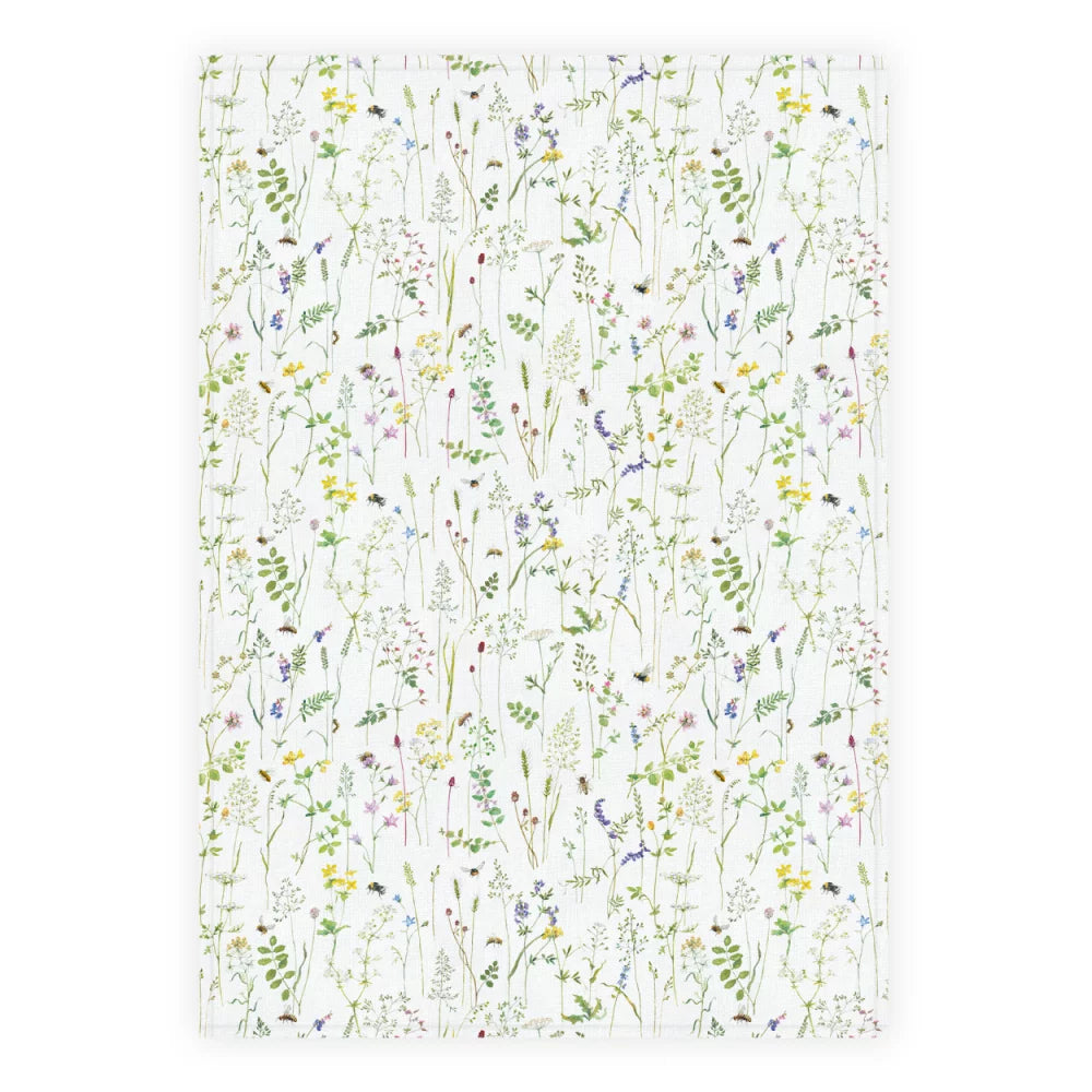 Floral patterned fabric with colorful wildflowers on a white background, perfect for crafts and decor.